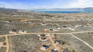 Birds eye view of property featuring a water and mountain view