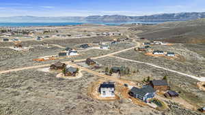 Birds eye view of property with a water and mountain view