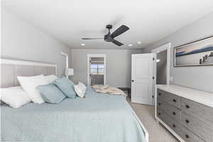 Bedroom with recessed lighting, a ceiling fan, and light carpet