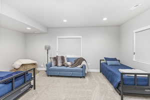 Carpeted bedroom with recessed lighting, baseboards, and visible vents