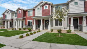 Multi unit property with a front yard, a porch, and stone siding