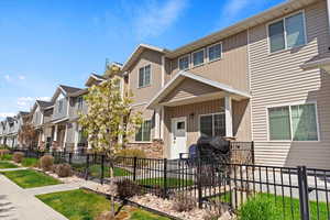 View of property with fence, board and batten siding, and a residential view