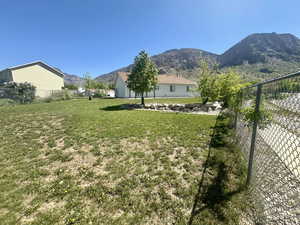 View of yard with fence and a mountain view