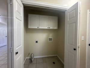 Laundry room with laundry area, light tile patterned flooring, baseboards, electric dryer hookup, and washer hookup