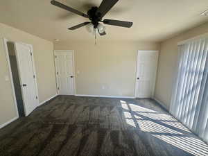 Unfurnished bedroom with baseboards, a textured ceiling, carpet, and ceiling fan