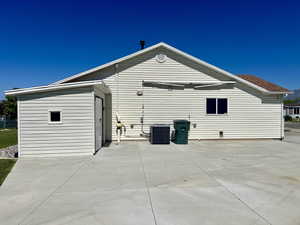 Back of house featuring a patio area and cooling unit