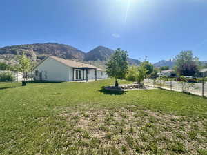 View of yard featuring a mountain view and fence