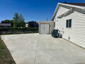 View of patio featuring a storage shed and an outdoor structure