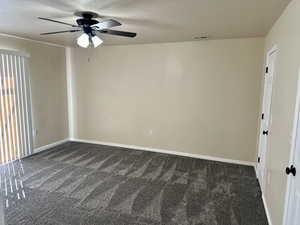 Unfurnished room with visible vents, carpet flooring, a textured ceiling, and ceiling fan
