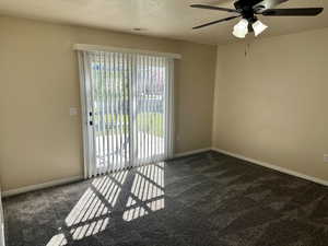 Carpeted spare room featuring a ceiling fan, a textured ceiling, visible vents, and baseboards