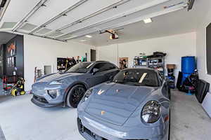 Garage featuring epoxy floors and car chargers.