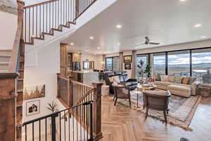 Living room with a ceiling fan and recessed lighting