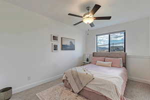 Bedroom featuring baseboards, ceiling fan, and carpet