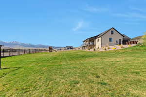 View of yard with fence and a mountain view