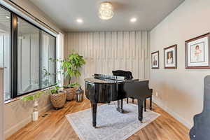 Living area featuring recessed lighting, baseboards, visible vents, and wood finished floors