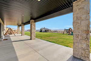 View of walkout patio / terrace featuring a playground and fence