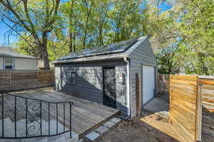 View of outbuilding with a fenced backyard and 1- car garage