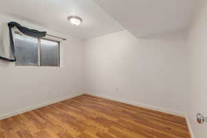 Empty room featuring baseboards and light wood finished floors