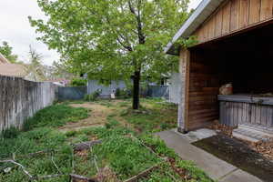 View of yard featuring a fenced backyard and a garden