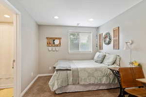Carpeted bedroom with baseboards, visible vents, and recessed lighting