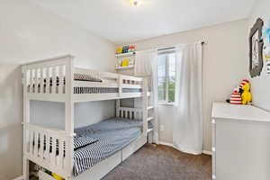 Carpeted bedroom featuring baseboards
