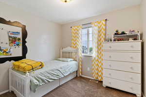 Bedroom featuring carpet floors, baseboards, and visible vents