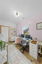 Office space with a textured ceiling and visible vents