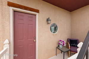 Doorway to property with stucco siding