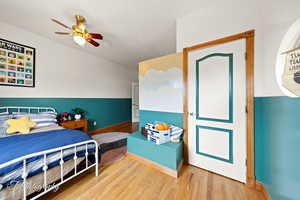 Bedroom featuring baseboards, ceiling fan, and wood finished floors