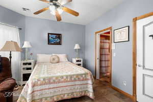 Bedroom featuring visible vents, a ceiling fan, and baseboards