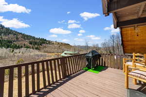 Deck with grill and pine chairs with amazing mountain view