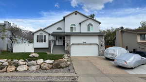 Front View. Stone Landscaping. Third Car Driveway. Gated Backyard.