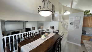 Dining Area. Vaulted Ceilings. Natural Lighting. View of Downstairs Living Room.