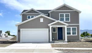 Traditional home featuring concrete driveway and board and batten siding