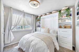Carpeted bedroom with baseboards and visible vents