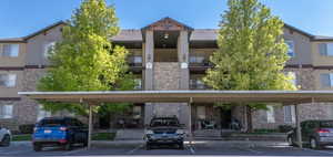 View of building exterior with covered parking