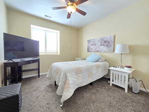 Carpeted bedroom featuring a ceiling fan, baseboards, and visible vents