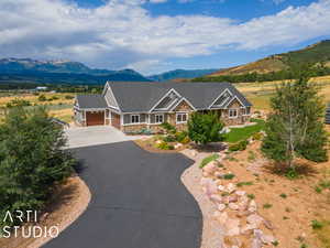 View of front of property with a mountain view and a garage