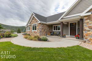 Exterior space with a porch and a front lawn
