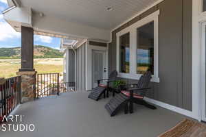 View of patio featuring a porch and a mountain view