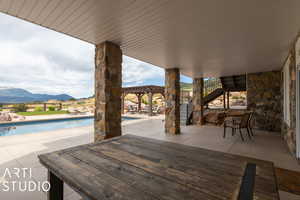 View of patio with a pergola and a mountain view