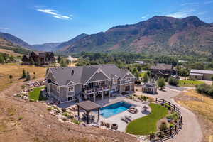 View of swimming pool featuring a mountain view, area for grilling, and a pergola