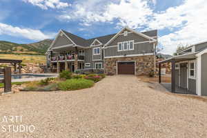 View of front facade featuring a pergola, a mountain view, a garage, and a balcony