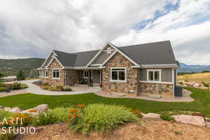 Craftsman-style home with a mountain view, central AC, and a front lawn