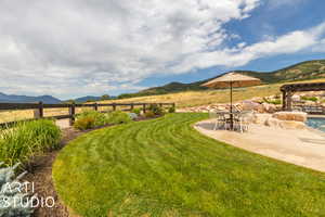 View of yard with a pergola, a mountain view, a patio area, and a rural view