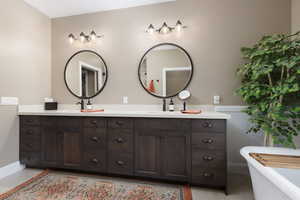 Bathroom featuring vanity, tile patterned flooring, and a washtub