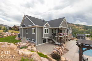 Rear view of property with a mountain view, a patio area, and central air condition unit