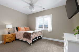 Bedroom with light carpet and ceiling fan