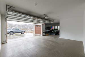 Garage featuring a carport, a mountain view, and a garage door opener