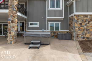 View of patio featuring a hot tub